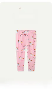 Detail of pink cotton kids leggings with colorful unicorn and floral print patterns