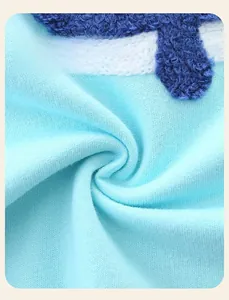 Close-up of light blue 100% cotton knit fabric with soft chenille embroidery detail