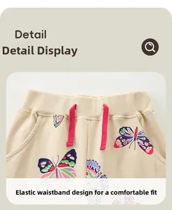 Detail of girls' jogger pants showing elastic ribbed waistband and red drawstring