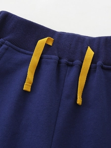 Kids navy joggers with yellow drawstring featuring knitted cotton fabric and elastic waist