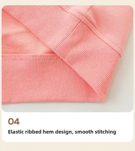 Detail of pink knitted cotton sweatshirt featuring elastic ribbed hem and neat stitching