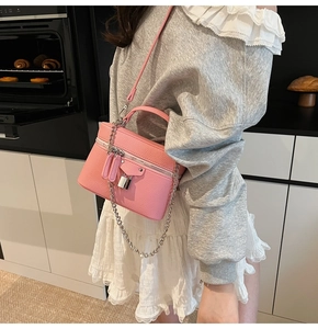 Pink lychee texture vanity case bag featuring silver lock and decorative chain strap detail