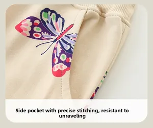 Detail of toddler girls joggers showing butterfly print and side pocket stitching