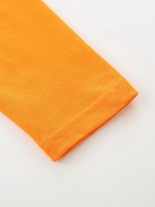 Detail of bright orange long sleeve cotton tee with premium double-needle stitching