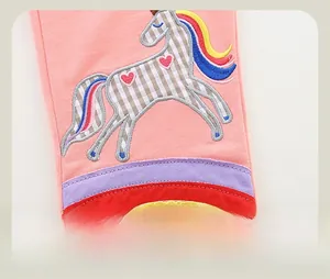Close-up of girls pink cotton joggers with unicorn embroidery and rainbow stripes detail