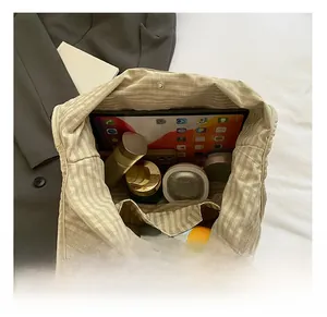 Top view showing the large capacity and inner pockets of the checkered canvas tote bag