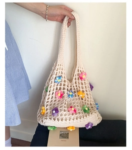 Detail of handmade crochet mesh tote bag with colorful 3D flower floral embroidery