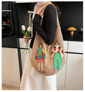 Detail of hand-woven beige knit tote bag with vibrant fashion figure patchwork embroidery