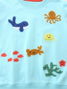 Girl's light blue cotton sweatshirt with sea creature towel embroidery and ribbed hem