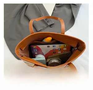 Top view of spacious striped tote bag interior showing laptop and daily essentials