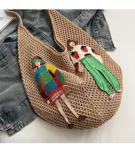 Detail of hollow knit tote bag with colorful pop-art cartoon girl embroidery patches