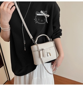 White lychee pattern leather crossbody bag with silver hardware on model detail view