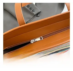Detail showing high-quality silver zipper and brown leather trim on the rainbow tote bag