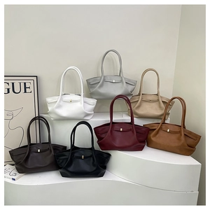 Collection of seven colorful tote bags on display showing various elegant leather options