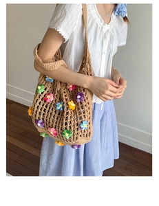 Detailed close-up of 3D crochet flowers on a handmade hollow knit shoulder bag