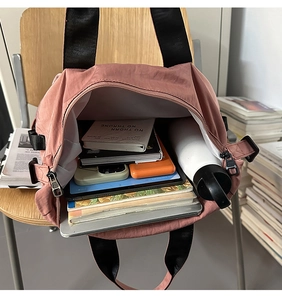 Spacious pink nylon tote bag interior showing large capacity for laptops and books