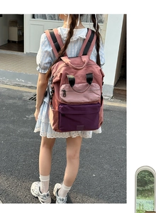 Detail showing back view of multi-pocket contrast canvas backpack on model outdoors