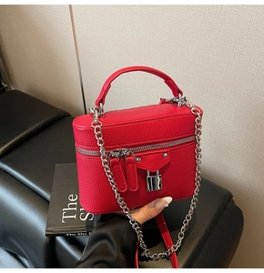 Detailed macro view of the red lychee pattern leather texture and silver buckle detail