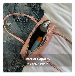 Top view showing the large interior capacity of this pink leather pillow bag with cosmetics
