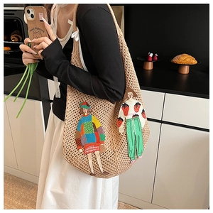 Detail of knitted tote bag featuring cute cartoon embroidery and hollow mesh texture