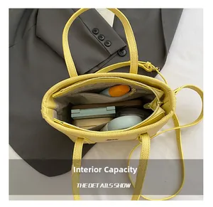 Interior storage space of the yellow bucket bag showing pockets for daily essentials