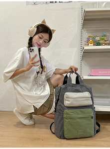 Detailed view of a multi-color canvas backpack showing large capacity and side pockets
