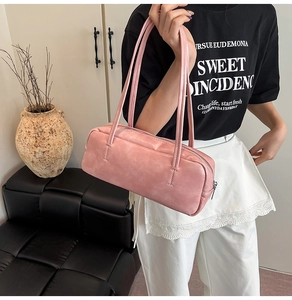 Pink minimalist pillow bag showing glossy marble texture and slim shoulder straps