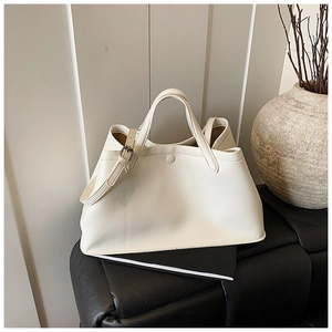 Detailed view of white PU leather bucket bag with metal buckle and detachable shoulder strap