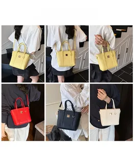 Multiple views of minimalist solid color bucket bags in yellow red black and white PU leather