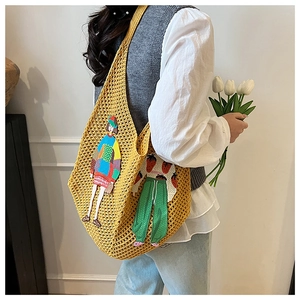Detail of yellow knit crochet tote bag with colorful embroidery patches and large capacity