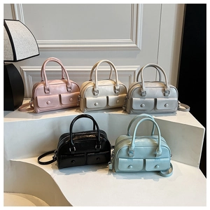 Five assorted Boston bags in pastel colors with front flap pockets and dual handles