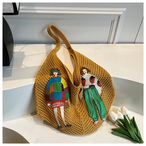 Detail of yellow hollow knit tote bag with exquisite cartoon girl embroidery texture