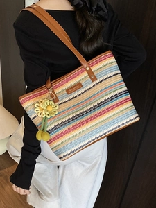 Chic multi-color striped straw tote bag with leather handles and sunflower charm
