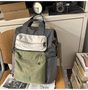 Detail of color-block backpack with multi-pocket design on a vintage campus background