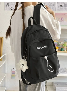 Detail of nylon pleated backpack with RKDBAG logo and white star plush pendant accessory