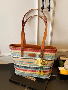 Colorful striped straw beach tote bag with brown leather straps and sunflower charm