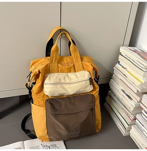 Detail of multi-color casual backpack with brand label and durable top handles