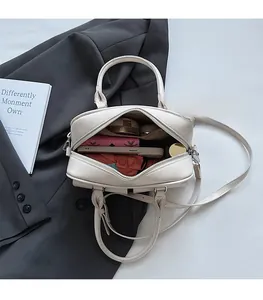 Spacious interior of beige Boston bag showing daily storage for phone and wallet