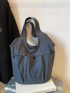 Classic checkered tote bag with dual front pockets for a casual and professional style