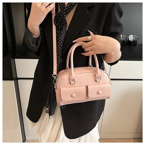 Close-up of pink PU leather Boston bag with silver hardware on a black blazer