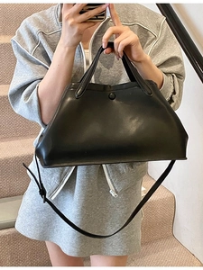 Fashionable black faux leather bucket tote bag with adjustable shoulder strap for women