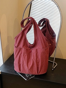 Red plaid canvas tote bag with outer pocket and wide shoulder strap in spacious design