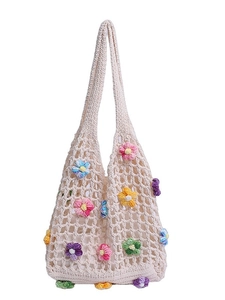 Crochet mesh tote bag with colorful floral decorations for summer beach vacations