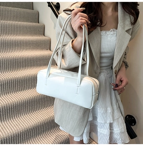 Minimalist white leather shoulder bag shown on model for elegant commuting style