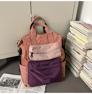 Detailed view of color-block nylon backpack with multi-pocket and top handles