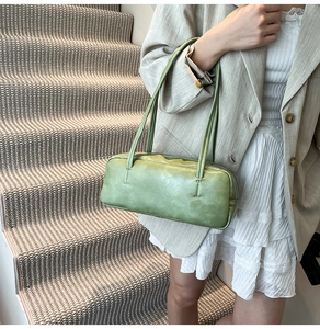 Chic light green rectangular shoulder bag styled with a beige blazer and pleated skirt