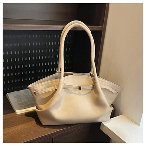 Detail of minimalist beige leather tote bag with long handles and decorative front strap