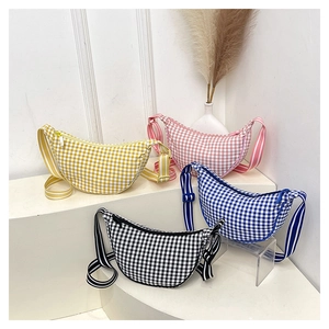 Detailed view of checkered half-moon crossbody bags in four colors on a white display