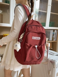 Pleated nylon backpack in burgundy with bear charm for school and travel use