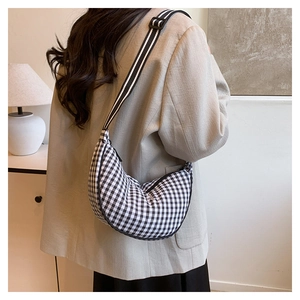 Detail of Gingham crescent crossbody bag with adjustable striped wide fabric strap
